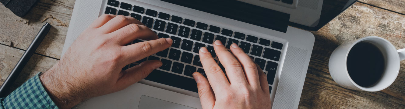 A man types on his keyboard.