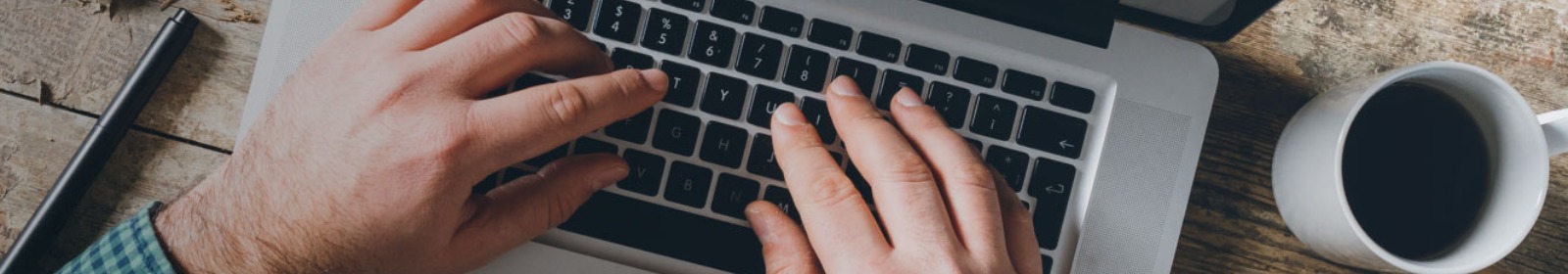 hands typing on a laptop computer