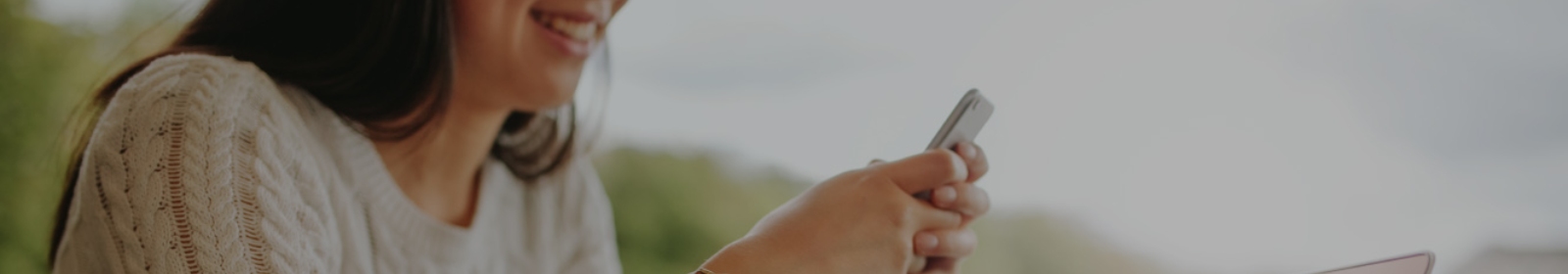 a woman looking at her mobile phone