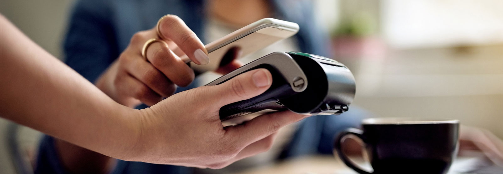 a person paying with their mobile phone